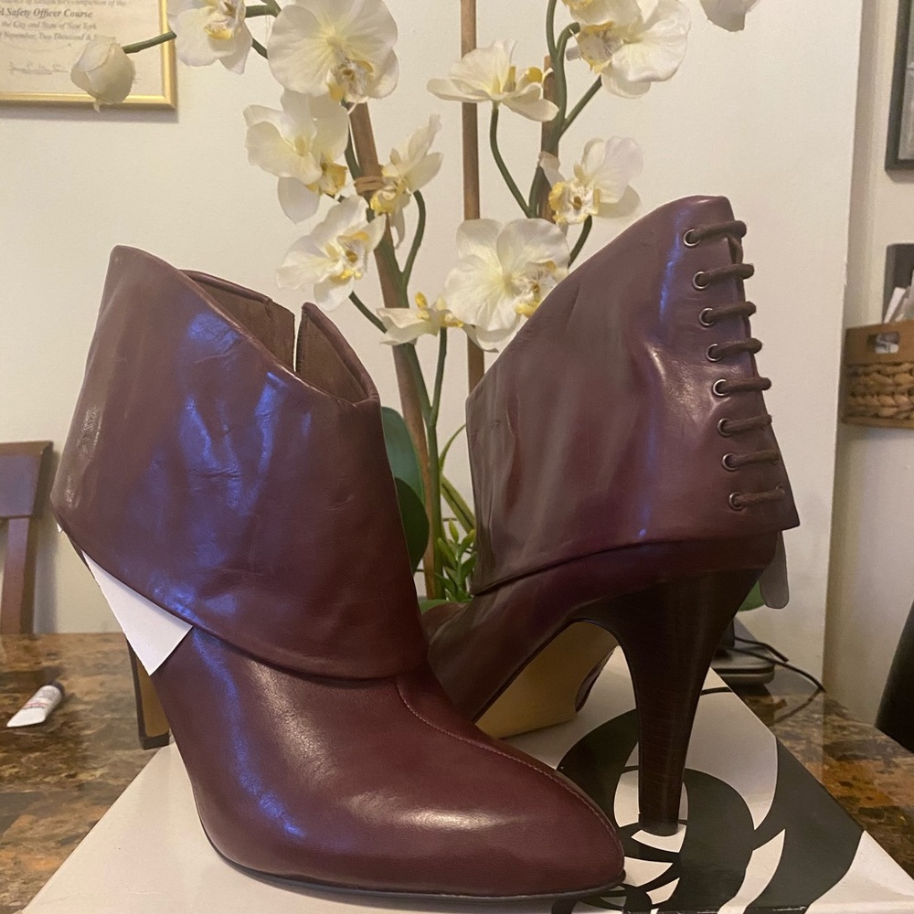 Never worn Nine West burgundy booties.